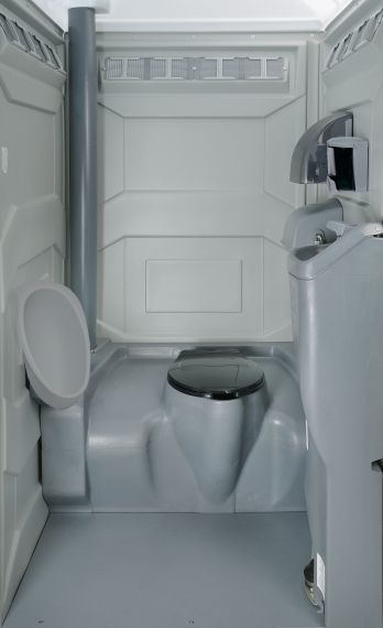 Compact white bathroom with a toilet, sink, and shower in a small enclosed space