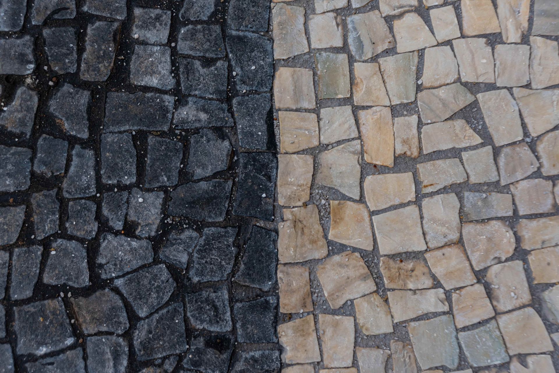 Black and beige cobblestone walkway with a vertical divide.