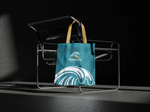 A teal tote bag with a white wave graphic and 