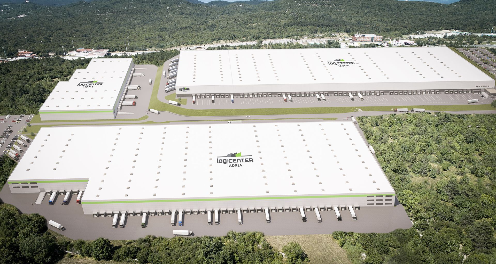 An aerial view of a large warehouse surrounded by trees
