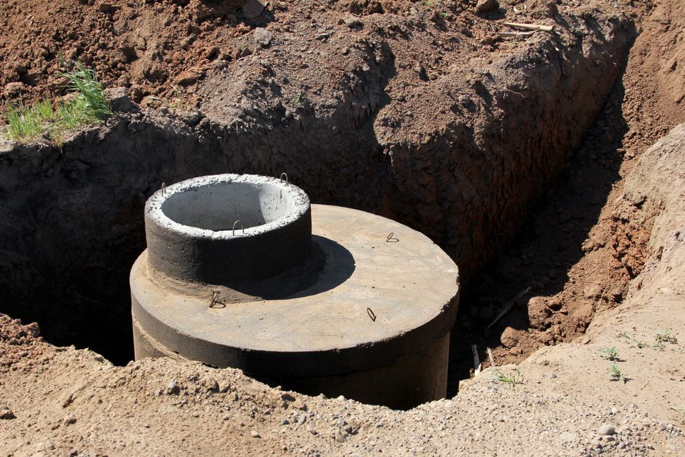 A Concrete Cylindrical Manhole Structure Sits Installed — Enviroplumb & Gas in Gracemere, QLD