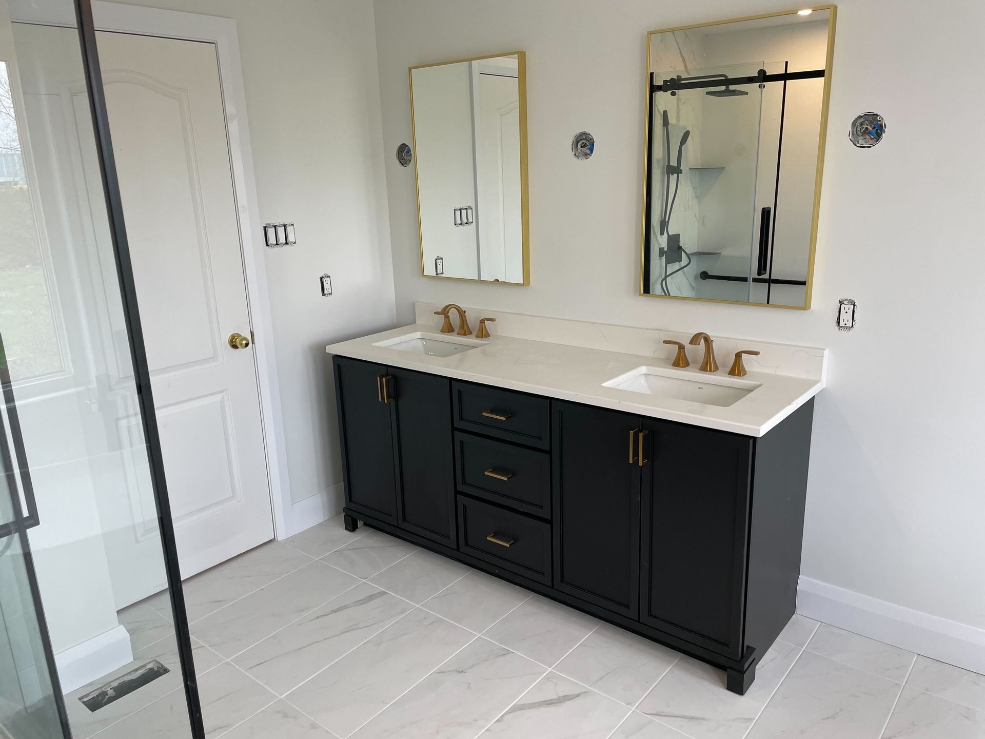 A bathroom with two sinks and two mirrors.