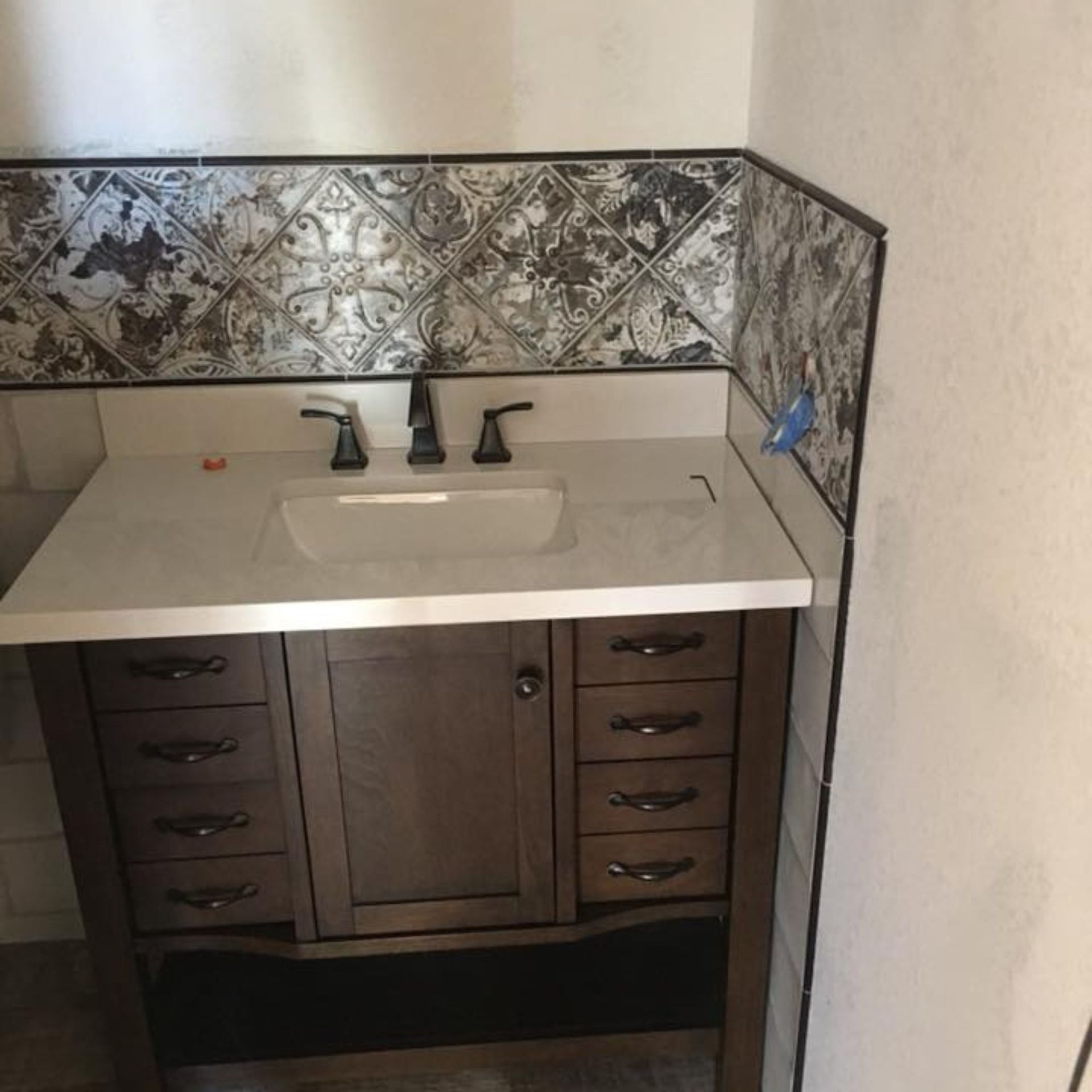 Masters Touch Roofing - A bathroom vanity with a sink and a faucet