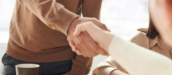 People shaking hands, a gesture of agreement or collaboration.