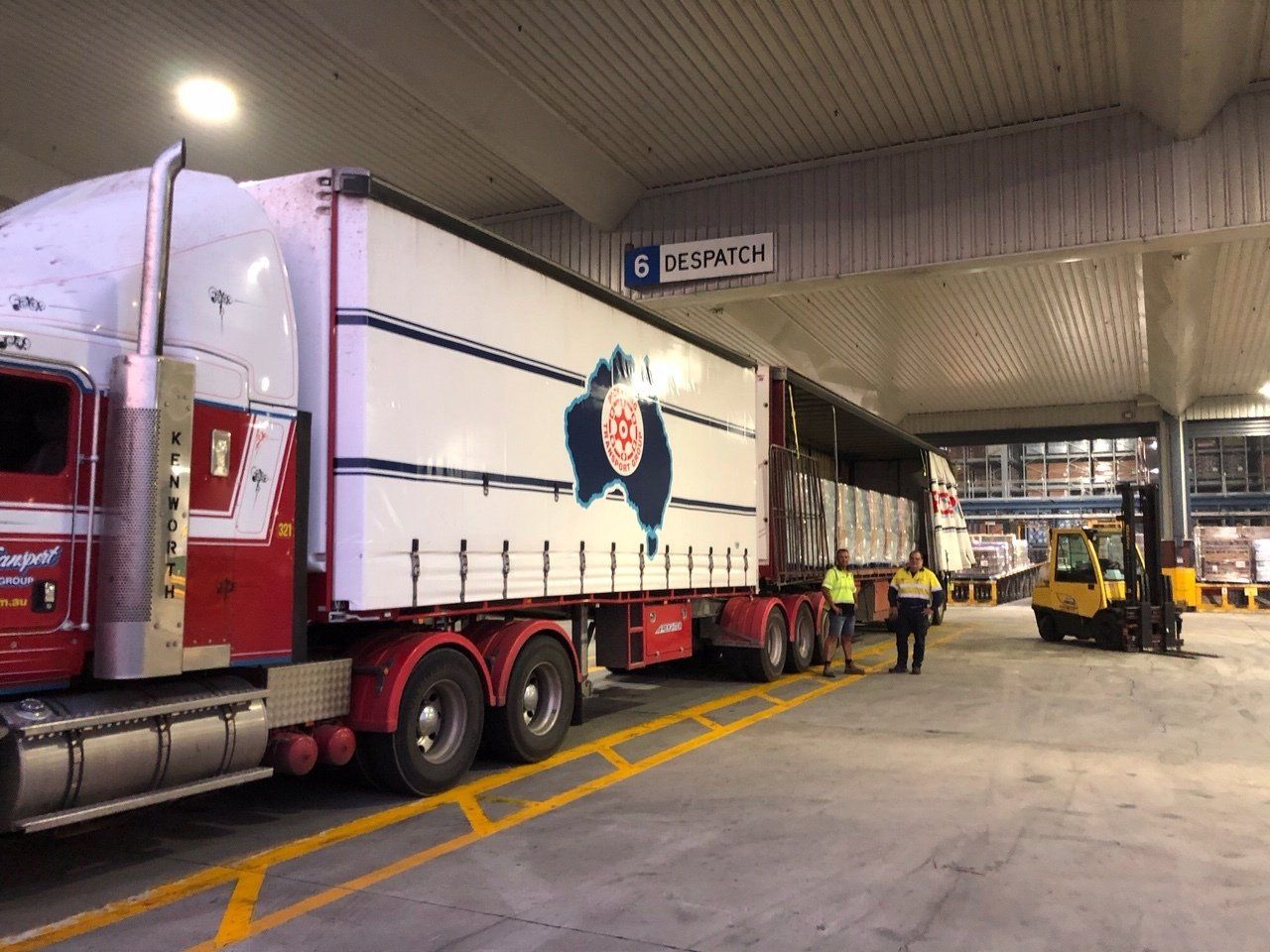 A Day Time Photo of a Truck and a Forklift Unloads Pallets of Water | Swan Hill, Vic | Pickering Transport Group