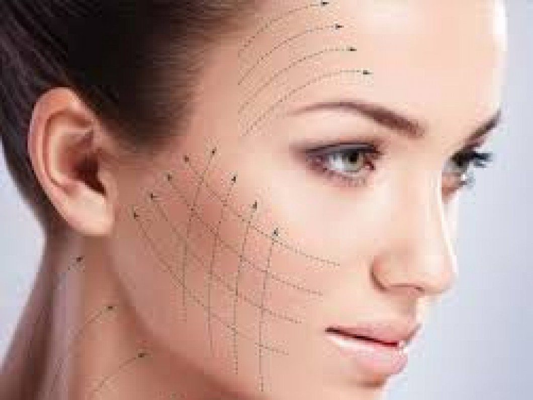 A close up of a woman 's face with lines drawn on it.