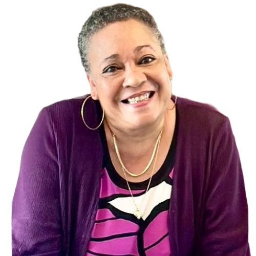 A woman wearing a purple cardigan and a purple shirt is smiling.