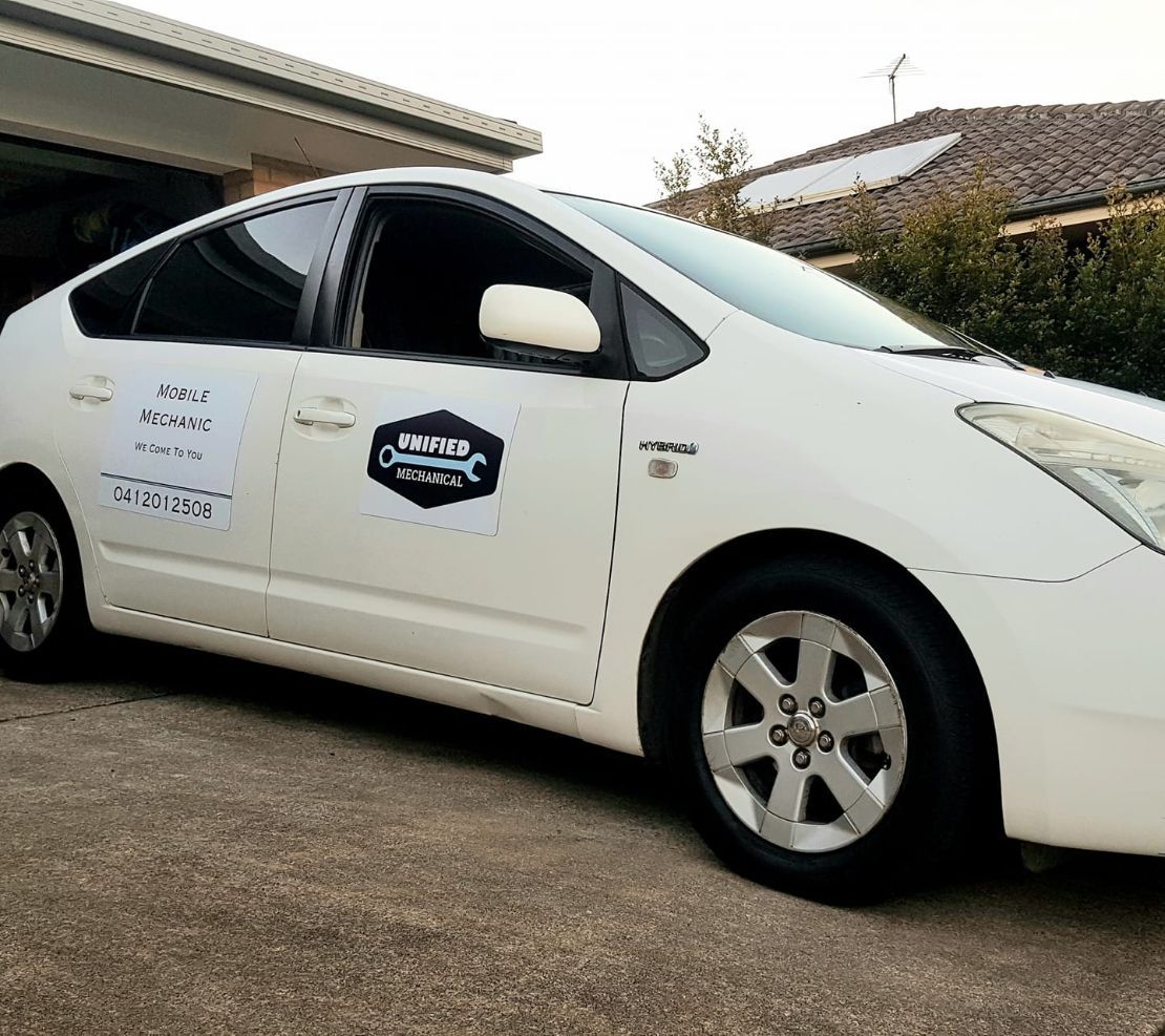 A White Prius is Parked in Front of a House — Unified Mechanical – Mobile Mechanic In Goonellabah, NSW