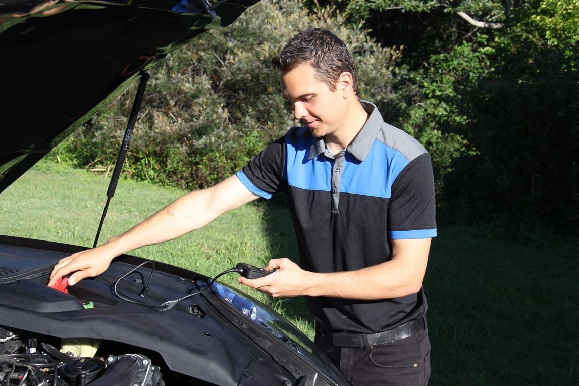 A Man is Looking Under the Hood of a Car — Unified Mechanical – Mobile Mechanic In Goonellabah, NSW