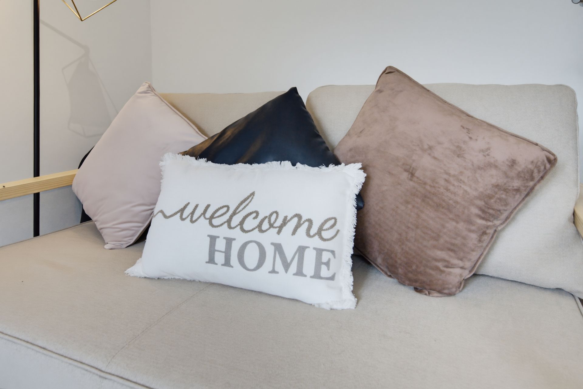 Decorative pillows on a light sofa, including a white