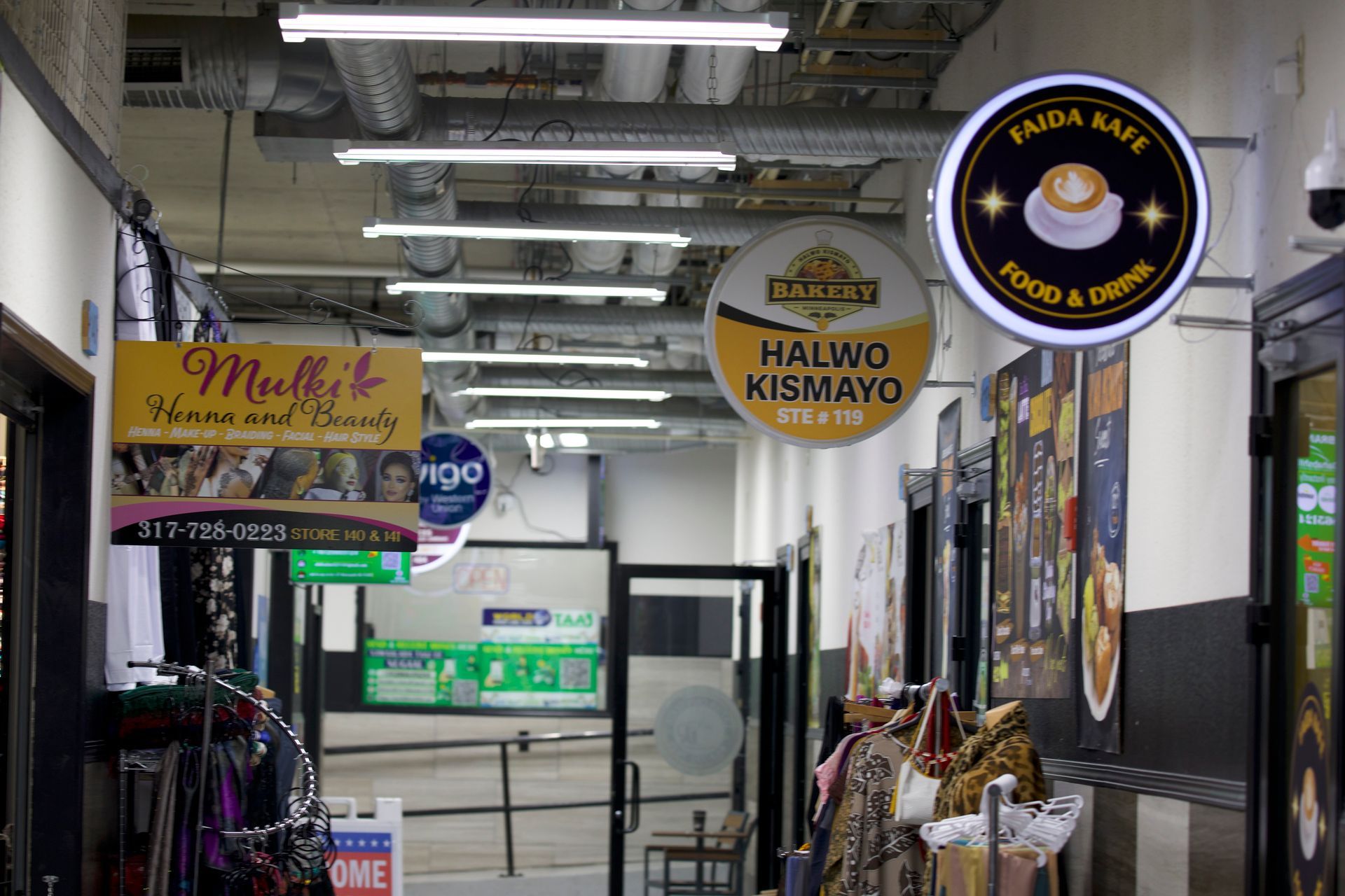 An alleyway with business signs, including