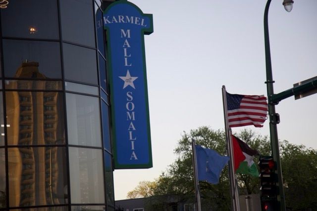 Karmel Mall Somalia sign with American, Somali, and EU flags.