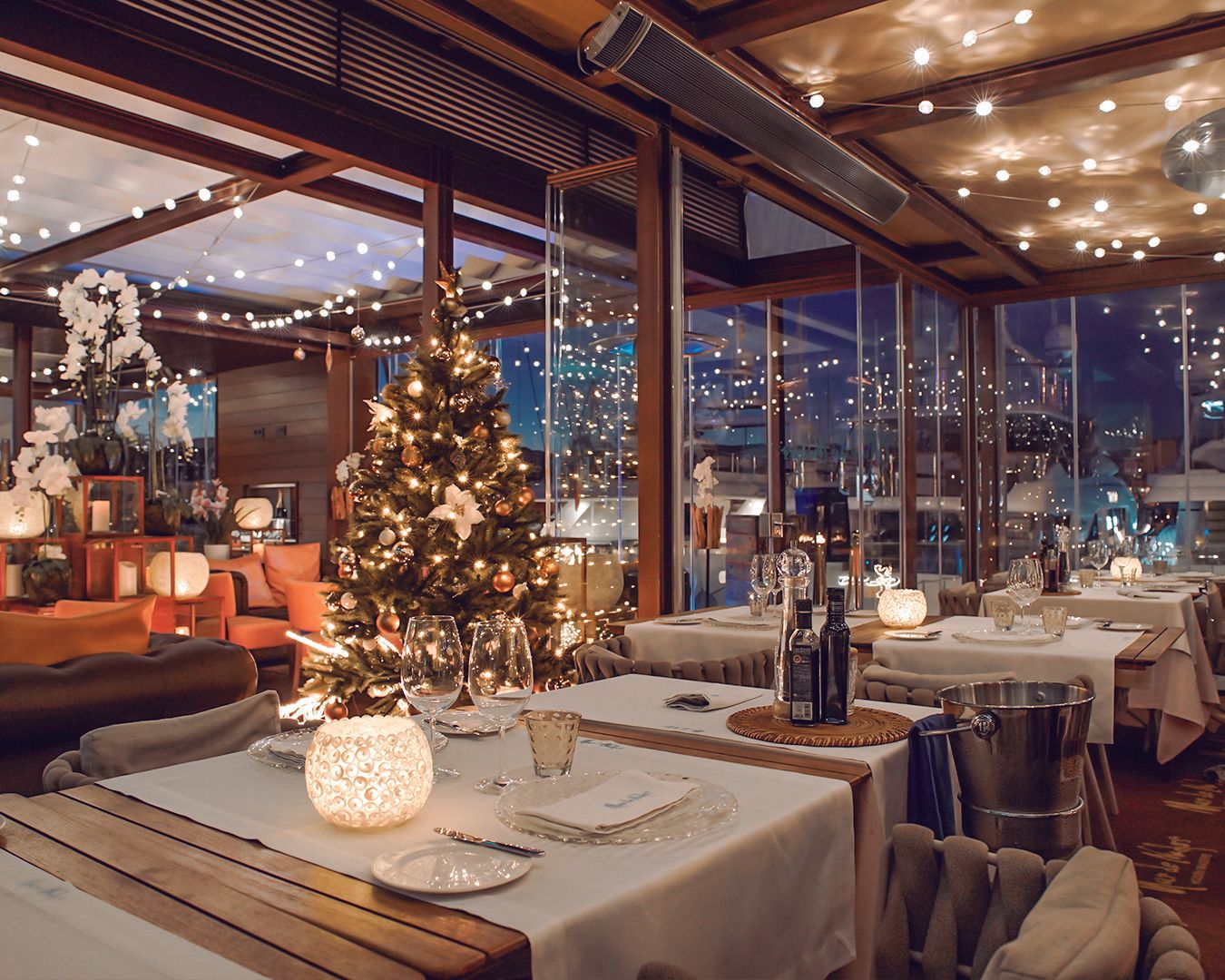 A christmas tree sits on a table in a restaurant