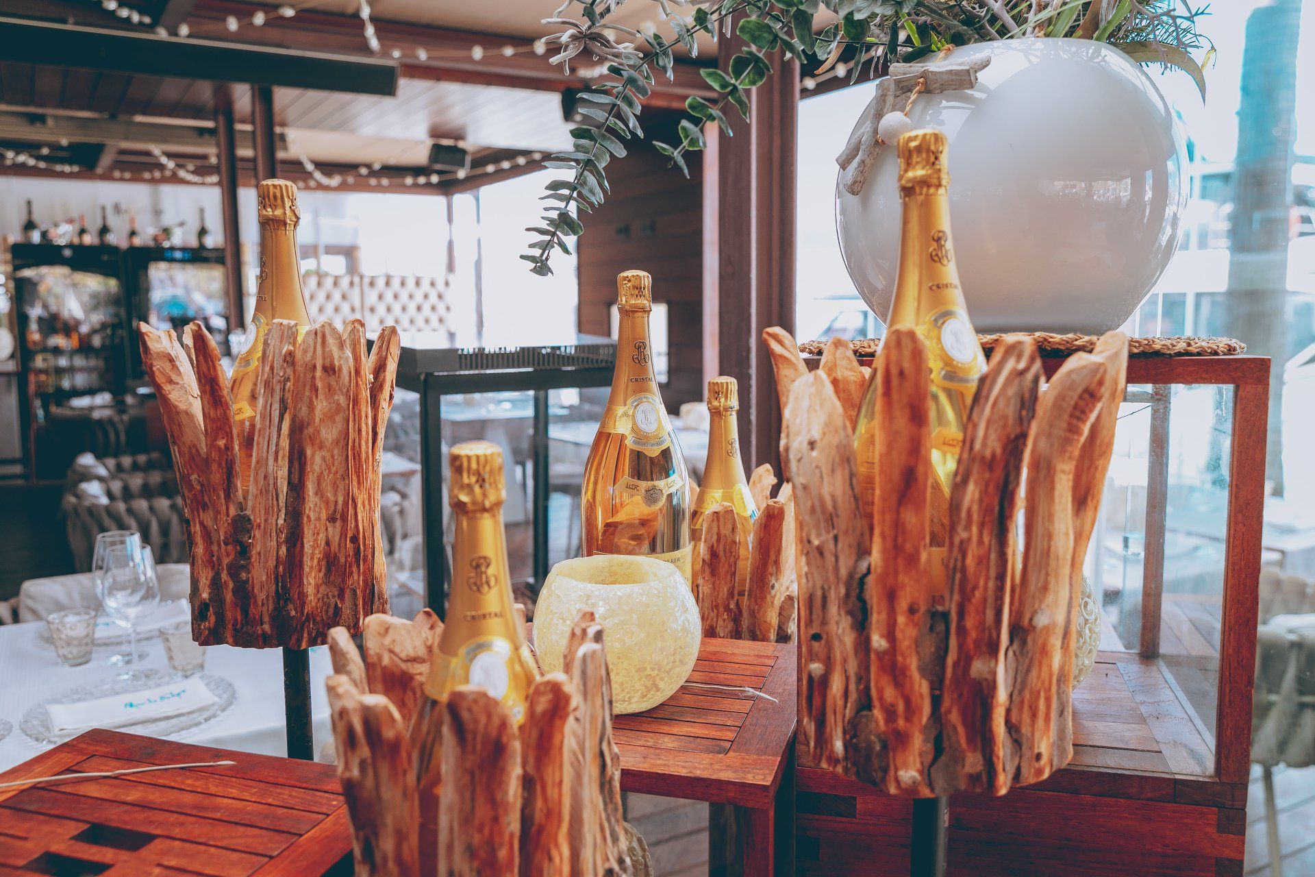 Several bottles of champagne are displayed in wooden buckets