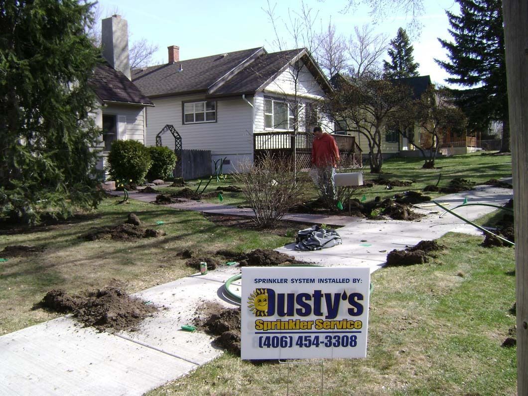 A yard with piles of soil and a sign for 