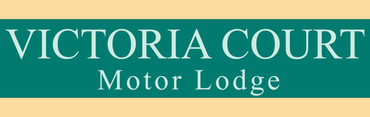 A green sign that says victoria court motor lodge