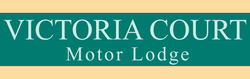 A green sign that says victoria court motor lodge
