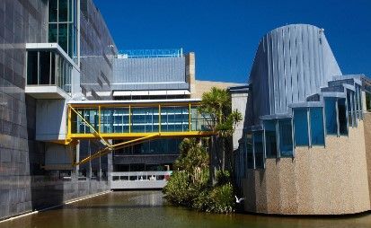 A large building with a bridge over a body of water