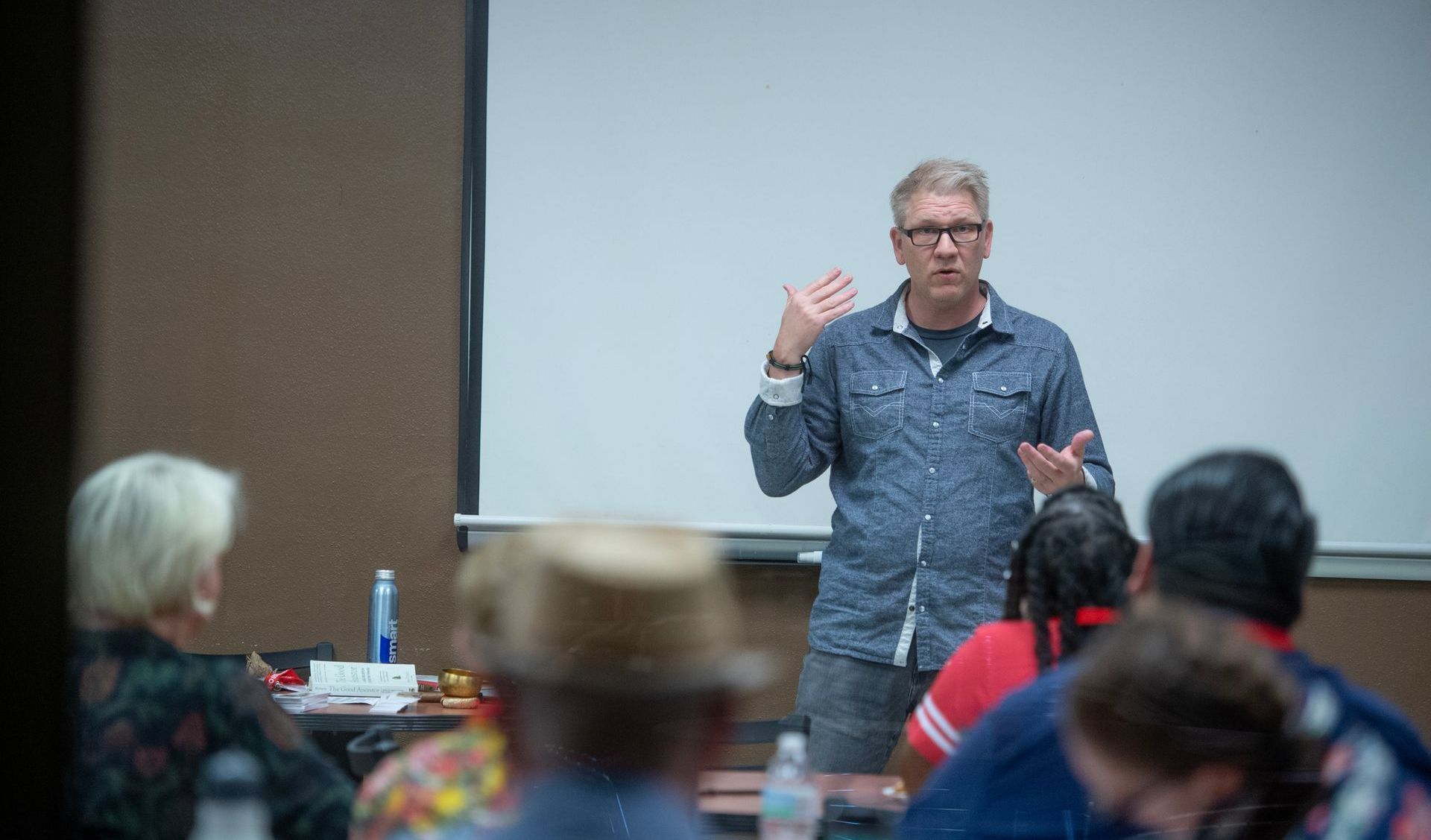 JT giving a presentation to a group of people in a classroom.
