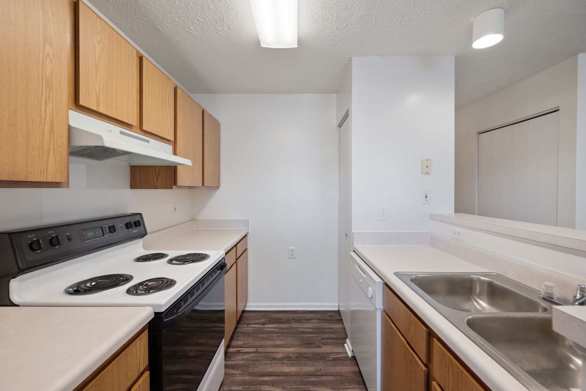 A kitchen with a stove , sink and dishwasher