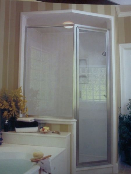 A bathroom with a walk in shower and a bathtub