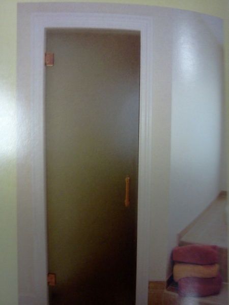 A picture of a door in a room with stairs in the background