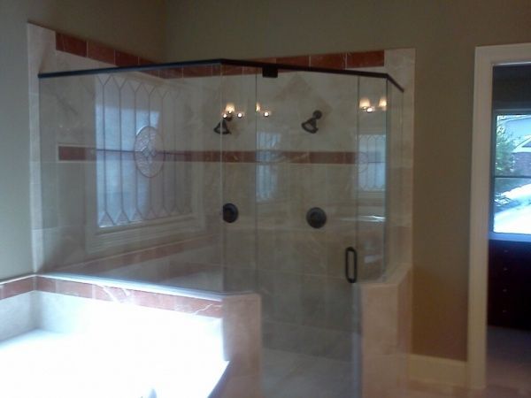 A bathroom with a bathtub and a shower stall