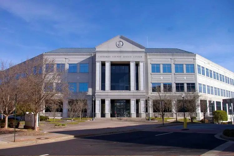 Exterior of the Forsyth County Courthouse building on a sunny day. White, multi-story structure with columns.