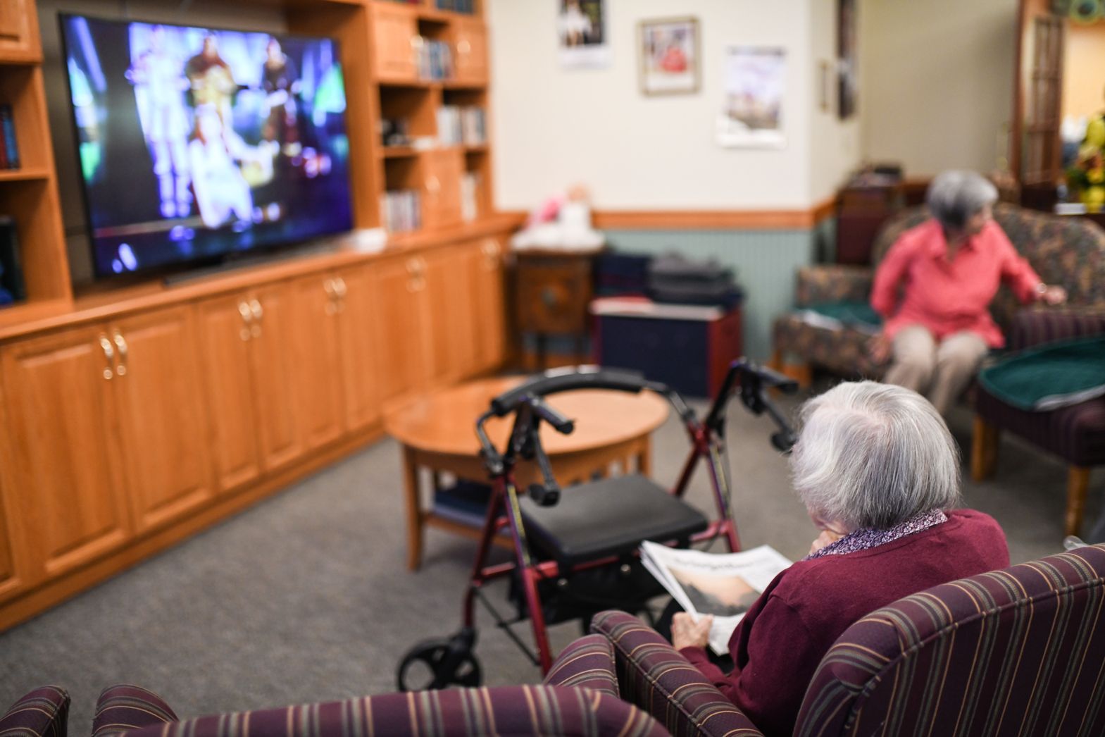 Residents gathered in the Bellamy Assisted Living lounge watching television