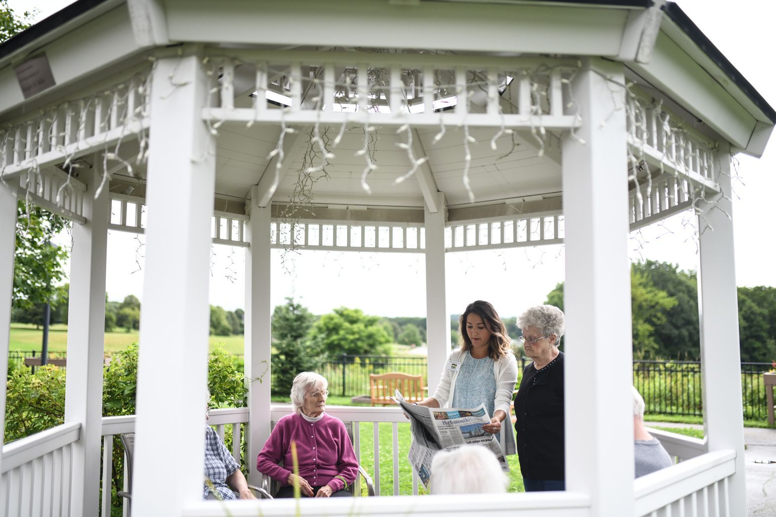 White gazebo in the Bellamy Assisted Living courtyard surrounded by greenery