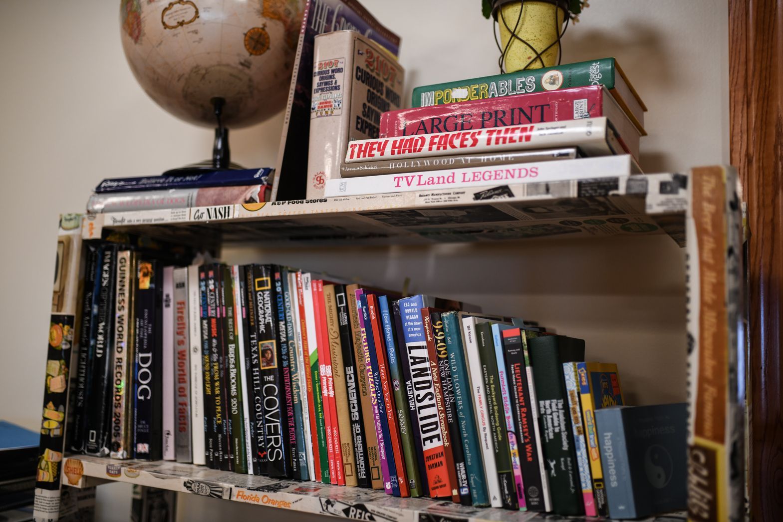 Books and board games arranged on a shelf in Bellamy Assisted Living activity area