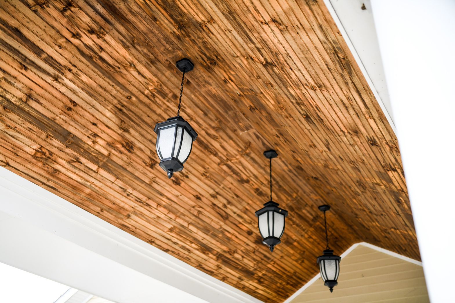 Wooden ceiling with elegant black light fixtures inside Bellamy Assisted Living