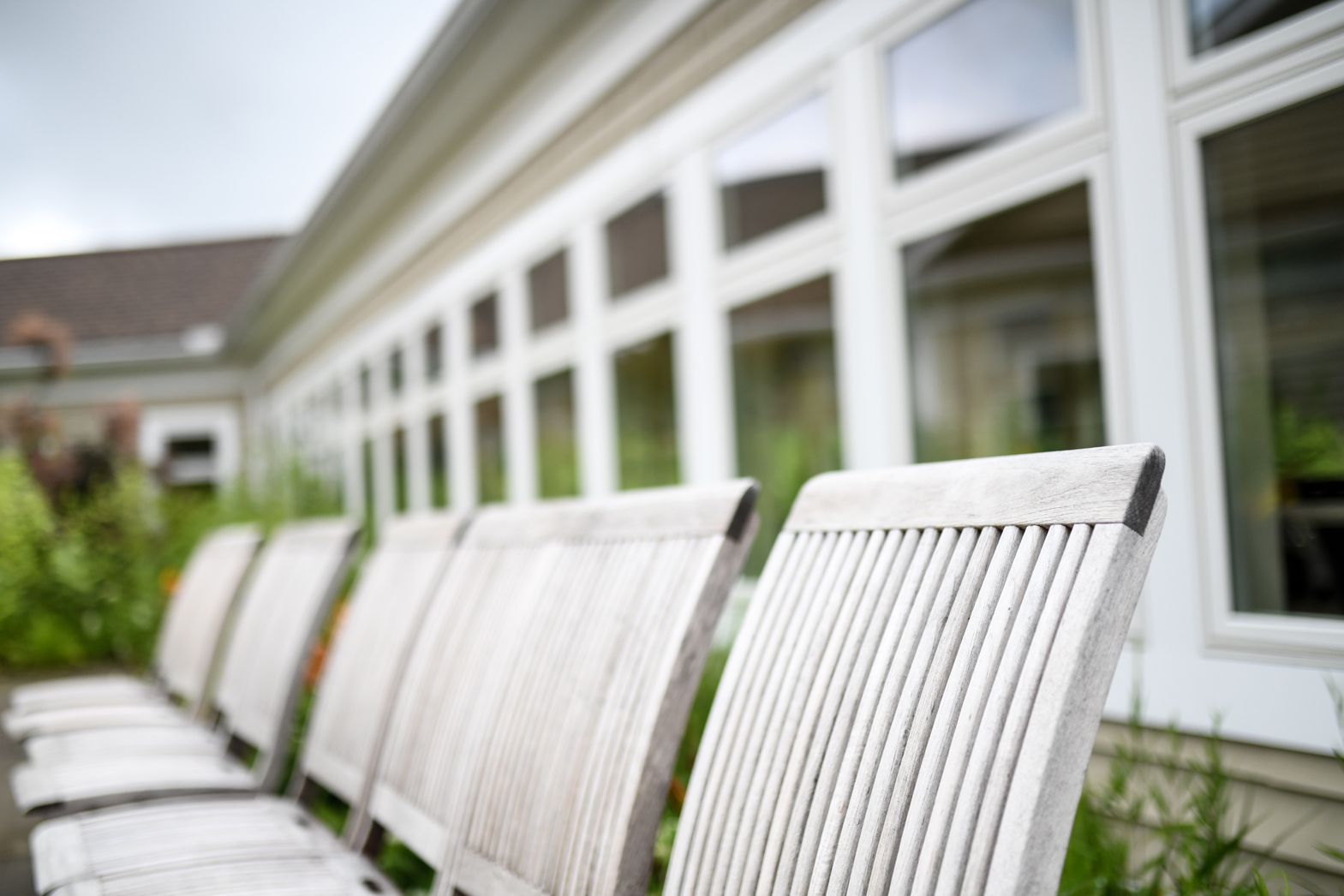 White chairs lined up along the patio at Bellamy Assisted Living