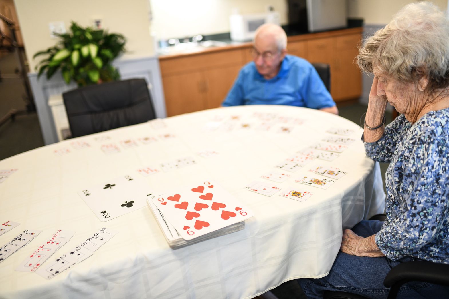 Residents enjoying a puzzle activity together at Bellamy Assisted Living