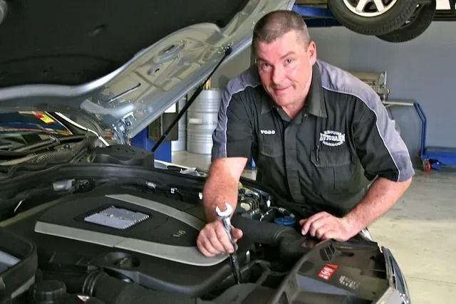 A Man Is Working Under The Hood Of A Car — Browns Autobahn In Nambour, QLD