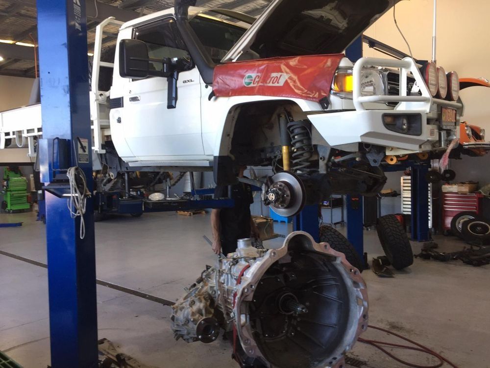 A White Truck With The Hood Up Is On A Lift In A Garage — Browns Autobahn In Nambour, QLD