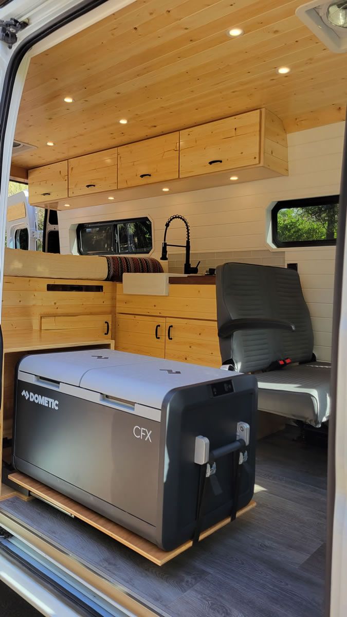 A cooler is sitting in the back of a van.