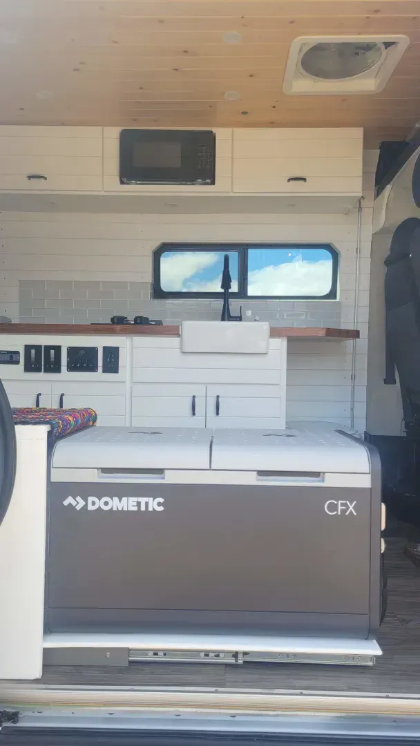A dometic refrigerator is sitting in the back of a van.