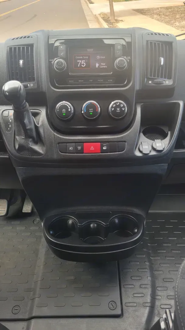 A close up of the dashboard of a car with a cup holder.