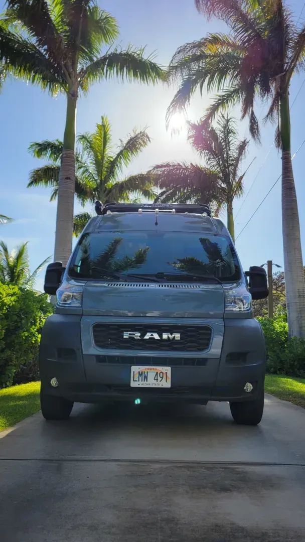RAM ProMaster front view under palm trees, available for rental by Mana Vans in Māʻalaea, Maui, HI.