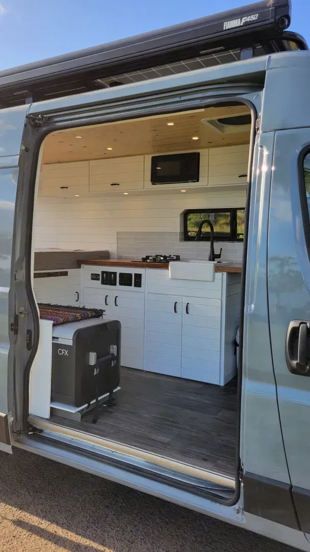 The inside of a camper van with the door open.