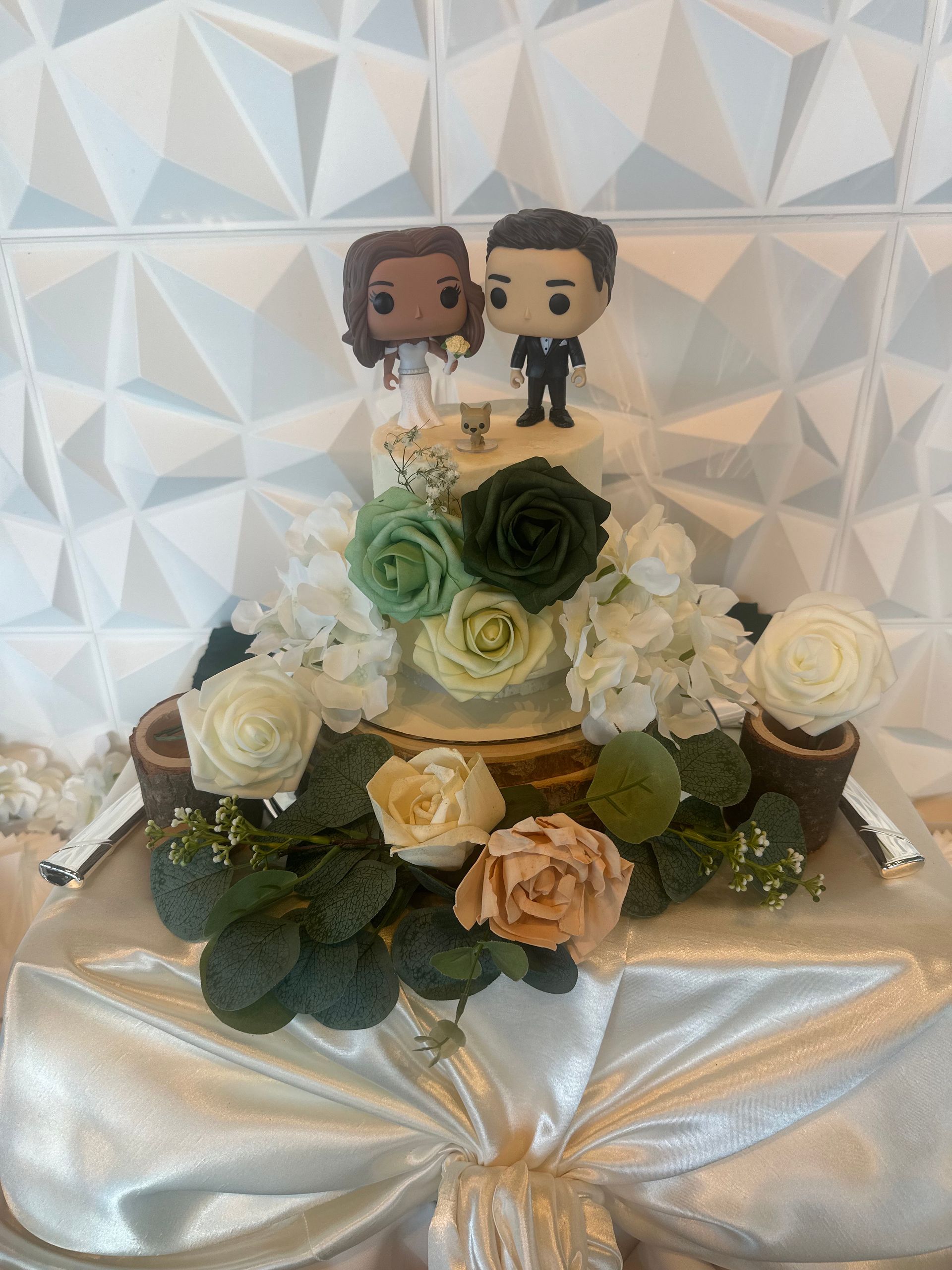 A wedding cake with a bride and groom figurine on top of it.