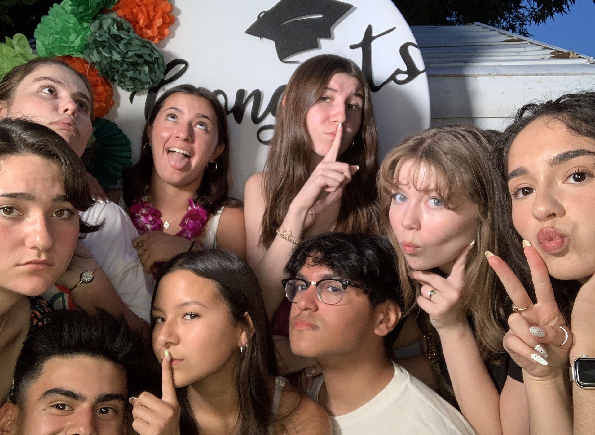 A two-column photostrip showing a group posing with party props at a
