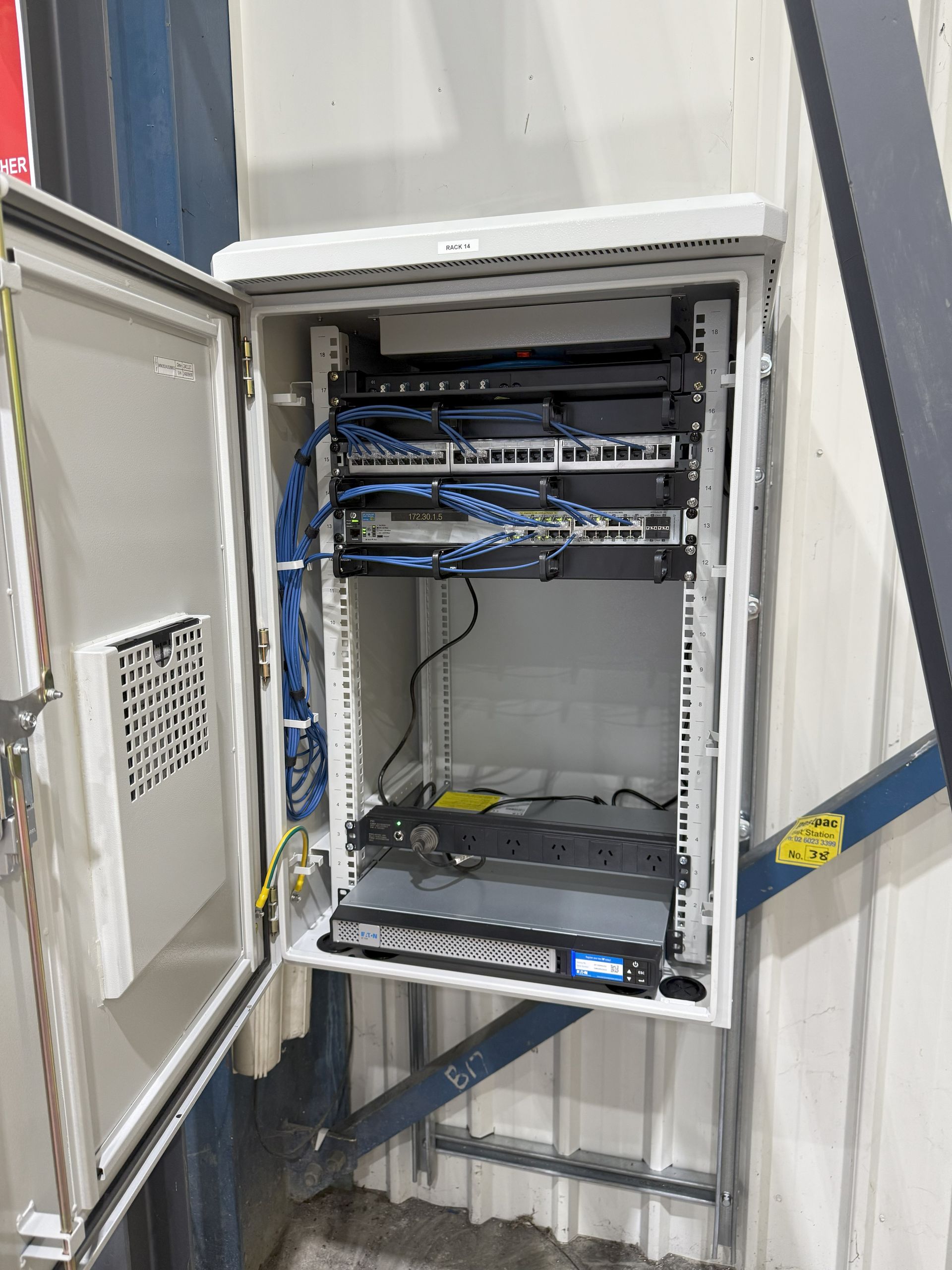 Blue Ethernet Cables Plugged Into Network Switches in a Server Room — INtelephony In Albury, NSW