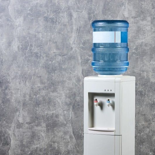 A White Water Cooler With a Large Blue Plastic Jug on Top Truck Commercial — Cool Blue Ice & Water in Taminda, NSW