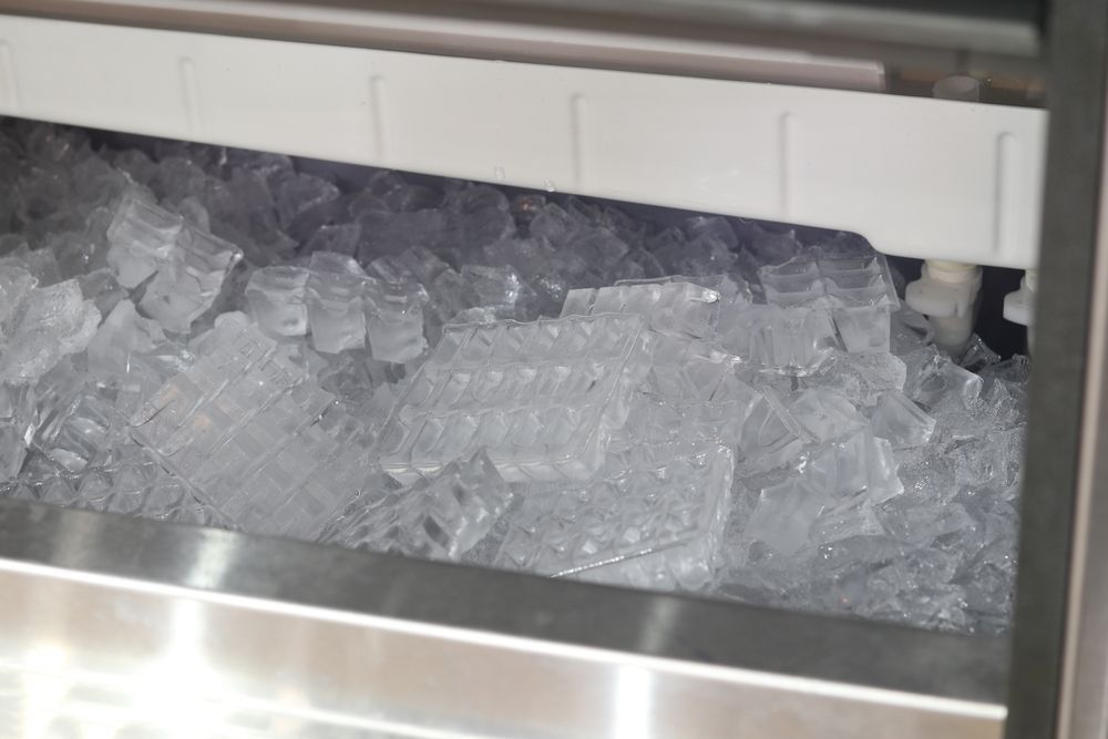 A Close-up View Looking Into a Stainless Steel Commercial Ice Machine Bin — Cool Blue Ice & Water in Singleton, NSW