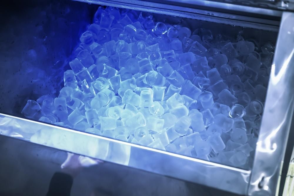 A Stainless Steel Bin Filled With Clear, Cylindrical Ice Cubes — Cool Blue Ice & Water in Taminda, NSW