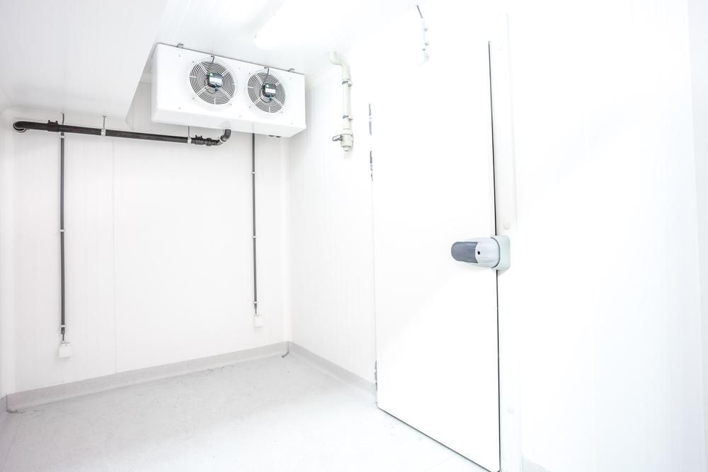 A Clean, White Walk-in Commercial Refrigerator With a Ceiling-mounted Cooling Unit — Cool Blue Ice & Water in Scone, NSW
