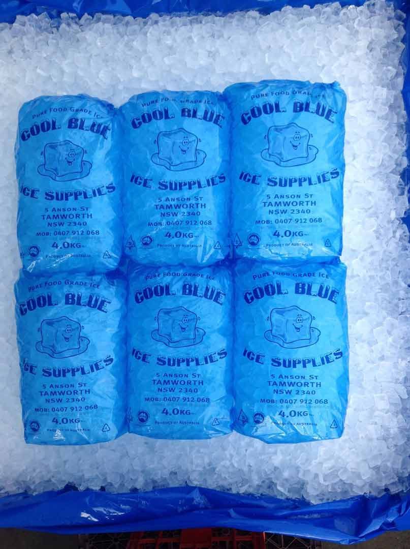 Six Blue Bags of Cool Blue Ice Supplies Nestled in a Bed of Crushed Ice — Cool Blue Ice & Water in Taminda, NSW