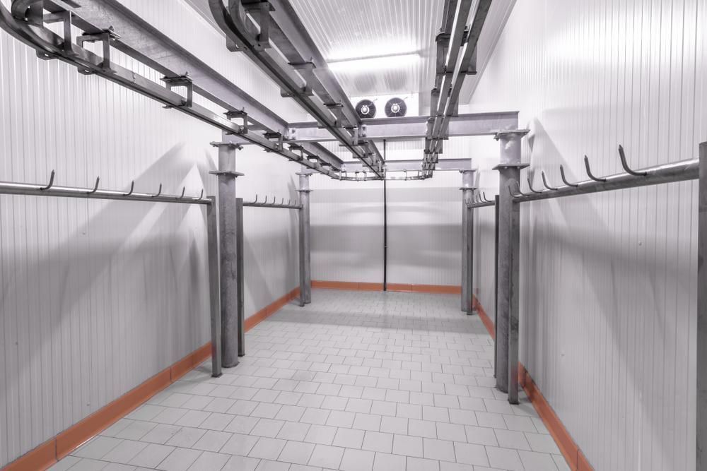 A Sterile Industrial Refrigerated Meat Storage Room With Overhead Trolley Rails — Cool Blue Ice & Water in Moree, NSW